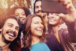 A group of multicultural friends taking a selfie.