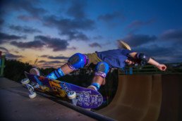 A skateboarder sideways on a ramp.
